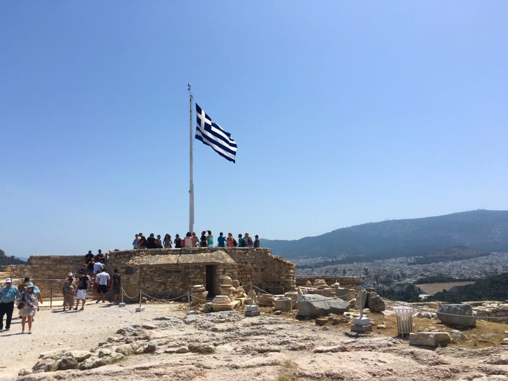 The Greek flag flying at the top of the Acropolis