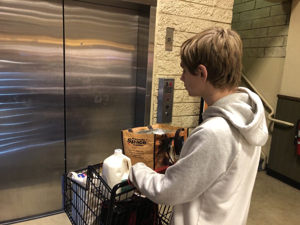 Kid pushing a shopping cart