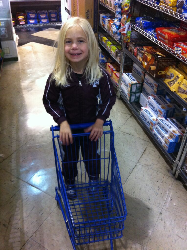 Kid pushing a shopping cart